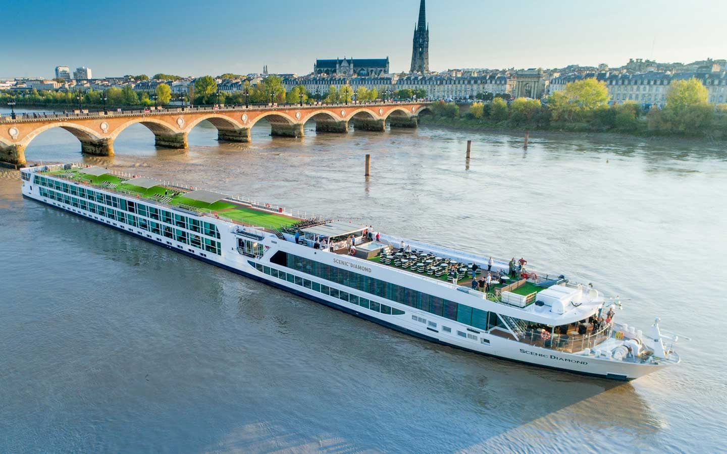 Scenic river ship on the Garonne by the Pont de Pierre in Bordeaux